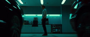 Movie still from “Twilight” (2008), directed by Catherine Hardwicke – A man standing in a kitchen in a room lit up with green lights; Wide shot, Low angle