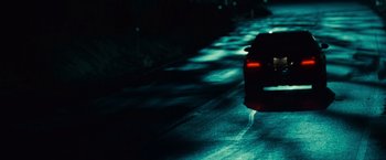 Movie still from “Twilight” (2008), directed by Catherine Hardwicke – A car driving down a street at night; Wide shot, High angle