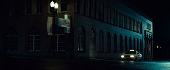 Movie still from “Twilight” (2008), directed by Catherine Hardwicke – A building that is lit up at night time; Extreme Wide shot, Low angle