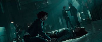 Movie still from “Twilight” (2008), directed by Catherine Hardwicke – A woman sitting on the ground in a dark room; Medium shot, Overhead angle