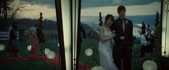 Movie still from “Twilight” (2008), directed by Catherine Hardwicke – A man and a woman standing next to each other on a lawn; Wide shot, High angle