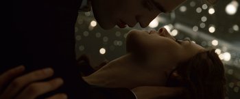 Movie still from “Twilight” (2008), directed by Catherine Hardwicke – A man and a woman kissing in the dark; Extreme Close Up shot, Low angle