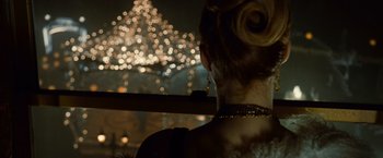 Movie still from “Twilight” (2008), directed by Catherine Hardwicke – A woman looking out of a window at a fireworks display; Close Up shot, Over the shoulder angle