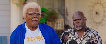 Movie still from “Tyler Perry's A Madea Homecoming” (2022), directed by Tyler Perry – Two older people sitting next to each other in a room; Medium shot, High angle