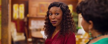 Movie still from “Tyler Perry's A Madea Homecoming” (2022), directed by Tyler Perry – A person wearing a red shirt; Close Up shot, Over the shoulder angle