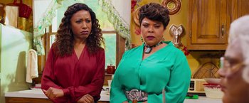 Movie still from “Tyler Perry's A Madea Homecoming” (2022), directed by Tyler Perry – Two women standing next to each other in front of a mirror; Medium shot, Over the shoulder angle