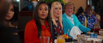 Movie still from “Tyler Perry's A Madea Homecoming” (2022), directed by Tyler Perry – A group of women sitting at a table with drinks; Medium shot, Over the shoulder angle