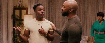 Movie still from “Tyler Perry's A Madea Homecoming” (2022), directed by Tyler Perry – Two men talking to each other in front of a mirror; Medium shot, Over the shoulder angle