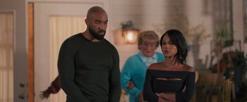 Movie still from “Tyler Perry's A Madea Homecoming” (2022), directed by Tyler Perry – A man and a woman standing next to each other in a room; Medium shot, Over the shoulder angle