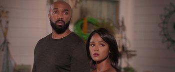 Movie still from “Tyler Perry's A Madea Homecoming” (2022), directed by Tyler Perry – A man and a woman standing next to each other; Close Up shot, Over the shoulder angle