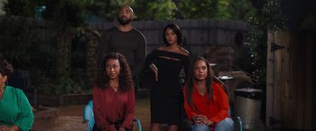 Movie still from “Tyler Perry's A Madea Homecoming” (2022), directed by Tyler Perry – A group of people standing next to each other in a yard; Wide shot, High angle