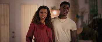 Movie still from “Tyler Perry's A Madea Homecoming” (2022), directed by Tyler Perry – A man and a woman standing next to each other in a room; Medium shot, Over the shoulder angle