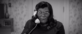 Movie still from “Tyler Perry's A Madea Homecoming” (2022), directed by Tyler Perry – An older woman wearing glasses talking on a phone; Close Up shot, High angle