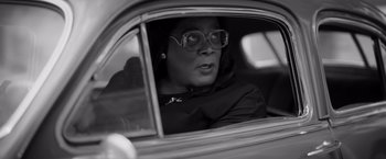 Movie still from “Tyler Perry's A Madea Homecoming” (2022), directed by Tyler Perry – A black and white photo of a woman driving a car; Close Up shot, Over the shoulder angle