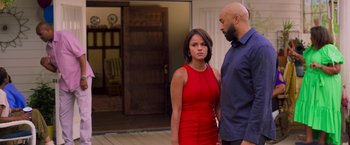 Movie still from “Tyler Perry's A Madea Homecoming” (2022), directed by Tyler Perry – A man and a woman standing next to each other in front of a door; Medium shot, Over the shoulder angle