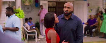 Movie still from “Tyler Perry's A Madea Homecoming” (2022), directed by Tyler Perry – A man and a woman standing next to each other; Medium shot, Over the shoulder angle