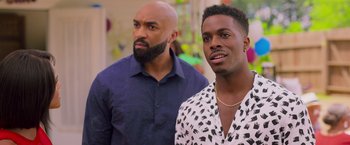 Movie still from “Tyler Perry's A Madea Homecoming” (2022), directed by Tyler Perry – Two men standing next to each other in front of a wall; Close Up shot, Over the shoulder angle