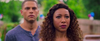 Movie still from “Tyler Perry's A Madea Homecoming” (2022), directed by Tyler Perry – A man and a woman standing next to each other in front of trees; Close Up shot, Over the shoulder angle