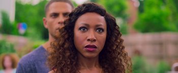 Movie still from “Tyler Perry's A Madea Homecoming” (2022), directed by Tyler Perry – A person with curly brown hair; Close Up shot, Over the shoulder angle