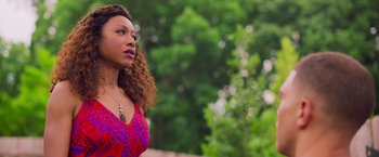 Movie still from “Tyler Perry's A Madea Homecoming” (2022), directed by Tyler Perry – A woman in a red and blue dress looking to her left; Close Up shot, Low angle
