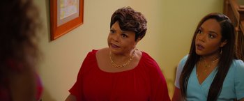 Movie still from “Tyler Perry's A Madea Homecoming” (2022), directed by Tyler Perry – A person wearing a red shirt; Medium shot, Over the shoulder angle