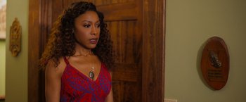 Movie still from “Tyler Perry's A Madea Homecoming” (2022), directed by Tyler Perry – A woman in a red and blue dress standing in front of a door; Close Up shot, Over the shoulder angle