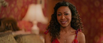 Movie still from “Tyler Perry's A Madea Homecoming” (2022), directed by Tyler Perry – A person wearing a necklace; Close Up shot, Over the shoulder angle