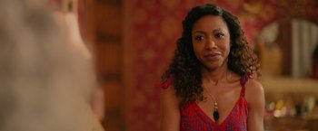 Movie still from “Tyler Perry's A Madea Homecoming” (2022), directed by Tyler Perry – A person with curly hair wearing a dress; Close Up shot, Over the shoulder angle