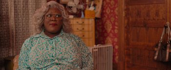 Movie still from “Tyler Perry's A Madea Homecoming” (2022), directed by Tyler Perry – A madea's family reunion movie scene with tyler perrys madea; Close Up shot, Over the shoulder angle