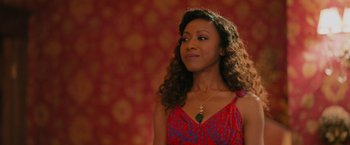 Movie still from “Tyler Perry's A Madea Homecoming” (2022), directed by Tyler Perry – A woman in a red and blue dress looking to her left; Close Up shot, Over the shoulder angle