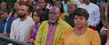 Movie still from “Tyler Perry's A Madea Homecoming” (2022), directed by Tyler Perry – A group of people sitting in front of each other; Medium shot, Over the shoulder angle