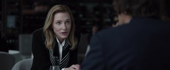 Movie still from “Tár” (2022), directed by Todd Field – A woman sitting at a table with a glass of wine in front of a man; Close Up shot, Over the shoulder angle