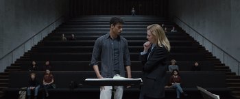 Movie still from “Tár” (2022), directed by Todd Field – A man and a woman standing next to each other; Medium shot, Over the shoulder angle