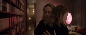Movie still from “Tár” (2022), directed by Todd Field – Two women are hugging in a dark room; Close Up shot, Over the shoulder angle