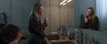 Movie still from “Tár” (2022), directed by Todd Field – A woman brushing her teeth in a bathroom; Medium shot, High angle