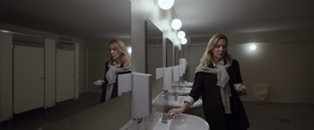 Movie still from “Tár” (2022), directed by Todd Field – A woman is washing her hands in a bathroom; Medium shot, Low angle