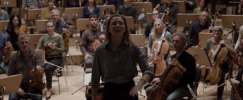Movie still from “Tár” (2022), directed by Todd Field – A woman standing in front of an orchestra; Medium shot, Low angle