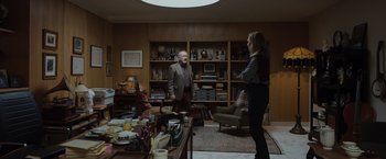 Movie still from “Tár” (2022), directed by Todd Field – A man and a woman are standing in a living room; Wide shot, Low angle