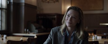 Movie still from “Tár” (2022), directed by Todd Field – A woman sitting in a chair in front of a window; Close Up shot, Over the shoulder angle