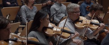 Movie still from “Tár” (2022), directed by Todd Field – A woman playing a violin in front of an audience; Close Up shot, Low angle