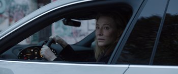 Movie still from “Tár” (2022), directed by Todd Field – A woman sitting in the driver's seat of a car; Close Up shot, Over the shoulder angle