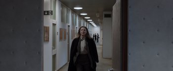 Movie still from “Tár” (2022), directed by Todd Field – A woman is walking down a hallway in a building; Wide shot, Low angle