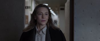 Movie still from “Tár” (2022), directed by Todd Field – A woman in a white shirt and a black jacket; Close Up shot, Low angle