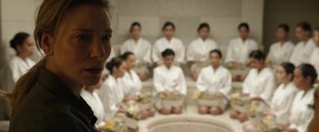Movie still from “Tár” (2022), directed by Todd Field – A group of women sitting in a room with food; Close Up shot, High angle