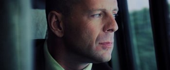 Movie still from “Unbreakable” (2000), directed by M. Night Shyamalan – A man's face looking off into the distance; Close Up shot, Low angle