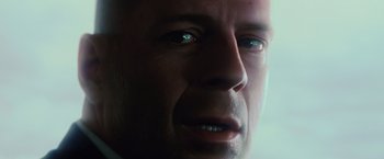 Movie still from “Unbreakable” (2000), directed by M. Night Shyamalan – A man's face in a dark room; Extreme Close Up shot, Low angle