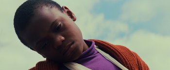 Movie still from “Unbreakable” (2000), directed by M. Night Shyamalan – A person wearing a purple shirt; Close Up shot, Low angle