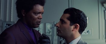 Movie still from “Unbreakable” (2000), directed by M. Night Shyamalan – Two men are looking at each other in a room; Close Up shot, Over the shoulder angle