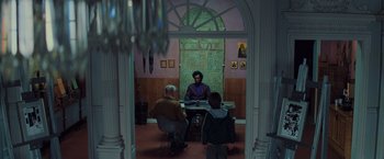 Movie still from “Unbreakable” (2000), directed by M. Night Shyamalan – A group of people sitting around a table; Wide shot, Over the shoulder angle