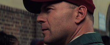 Movie still from “Unbreakable” (2000), directed by M. Night Shyamalan – A man wearing a red hat; Close Up shot, Over the shoulder angle